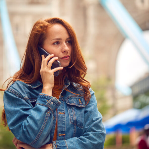 AVMH-EMDR (1) Female Vlogger Travelling Through London Making Phone Call On Mobile Phone By Tower Bridge