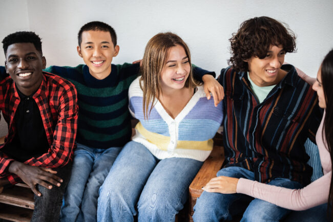 Young multiracial people having fun together – Focus on asian boy Young people learning about the difference between social anxiety and generalized anxiety disorder.