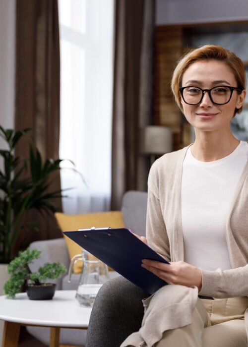 Beautiful smiling confident young blonde woman with a beautiful face looks at the camera. Psychologist or businesswoman at home in office, happy millennial professional close up front portrait