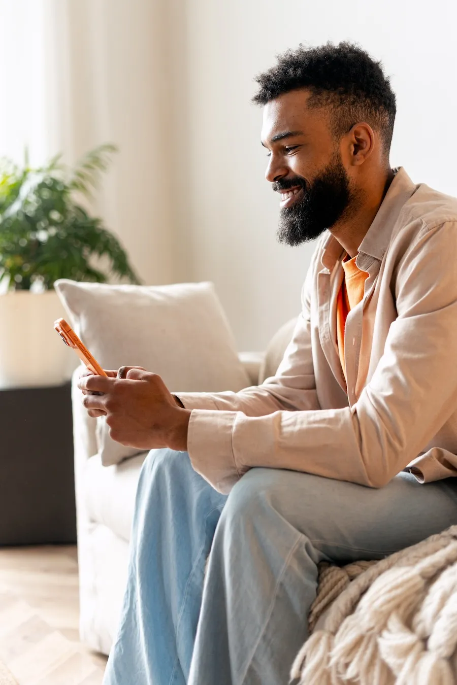 Aspen View Mental Health - young man smiling while using smartphone